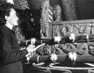 Beverly Cooper, 1949 Fulbright US Graduate Student, studies a Māori waka Beverly Cooper, 1949 Fulbright US Graduate Student, studies a Māori waka